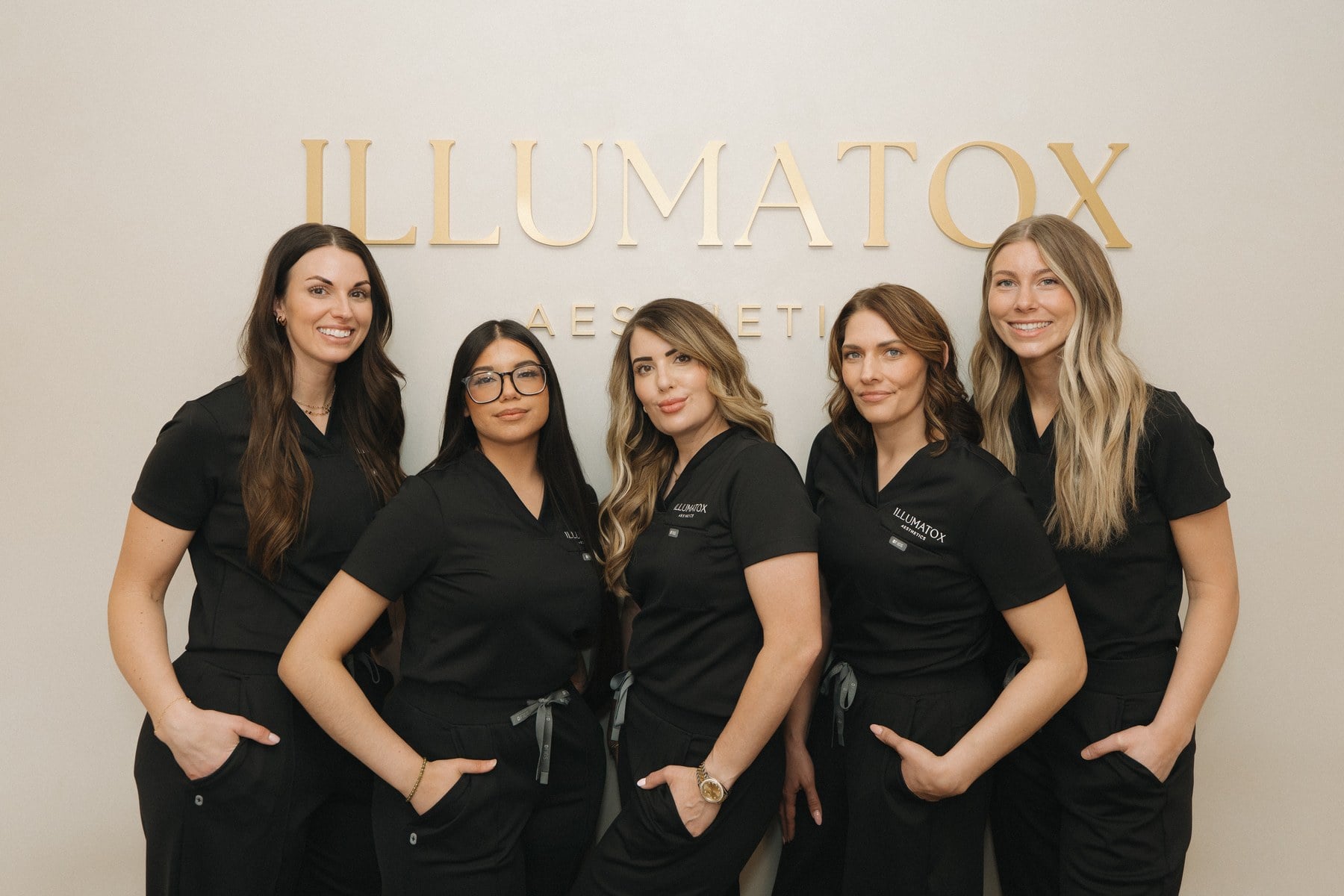 The Illumatox team photographed under the studio signage in downtown Neenah