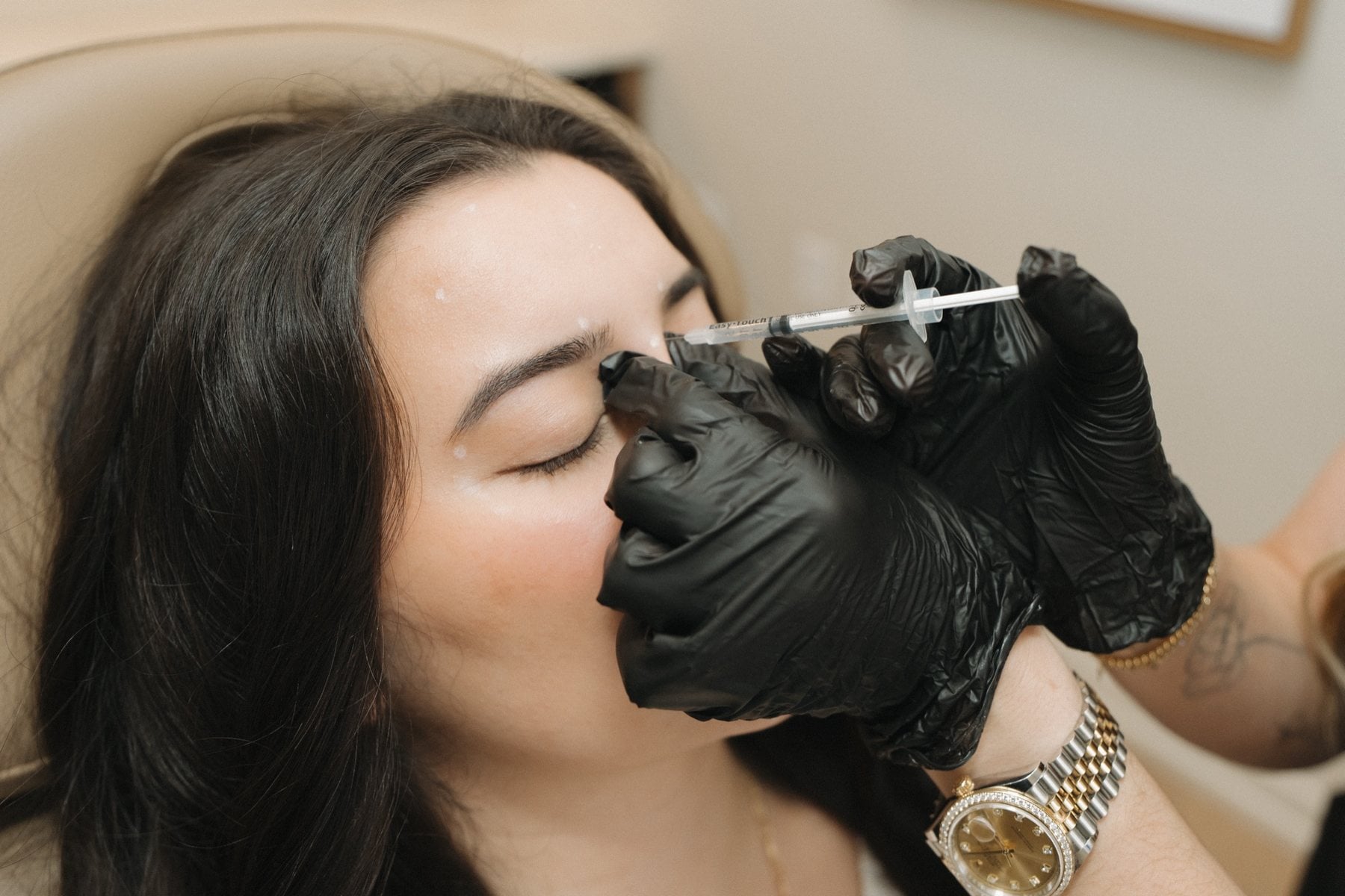 An injectable treatment being performed by a nurse practitioner at Illumatox in Neenah