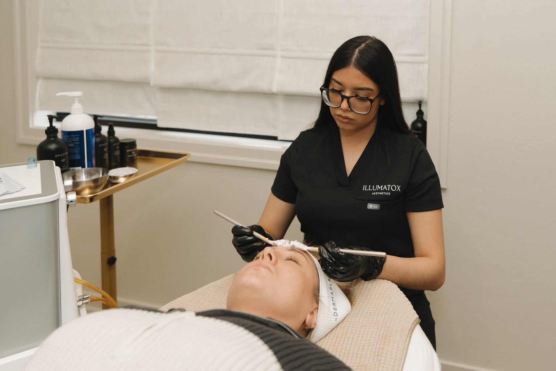 A treatment mask being applied during a facial at Illumatox